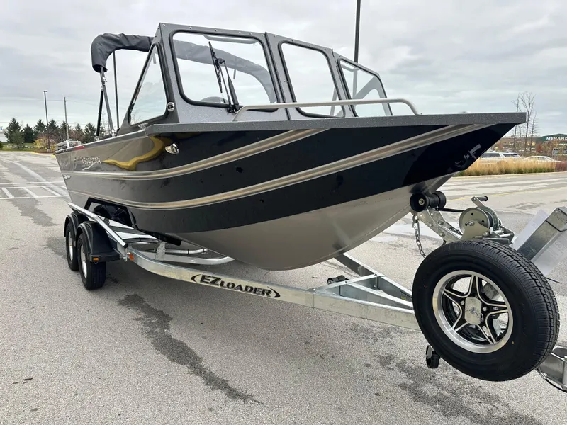 Slide: The Image of 2025 Spartan 200 Astoria boat on EZ Loader trailer in parking lot. - 5