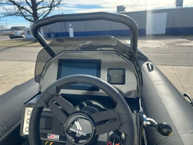 Slide: The Image of 2025 Highfield Velox 420 boat dashboard with steering wheel and digital display. - 3