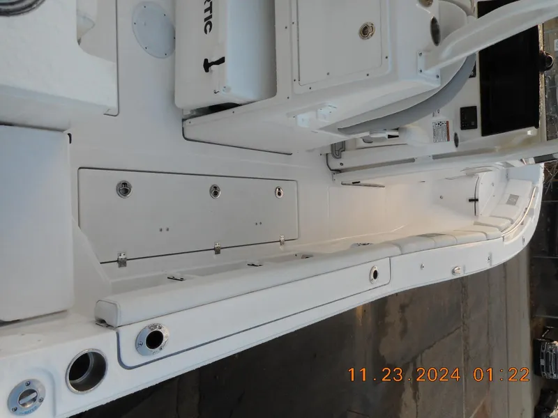 Slide: The Image of 2025 Sea Fox 288 Commander boat interior, featuring sleek white design and storage compartments. - 7