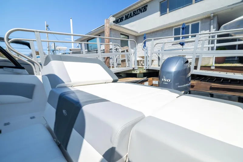 Slide: The Image of 2022 Chaparral 21 SSi OB boat with Yamaha 150 engine at dockside. - 11