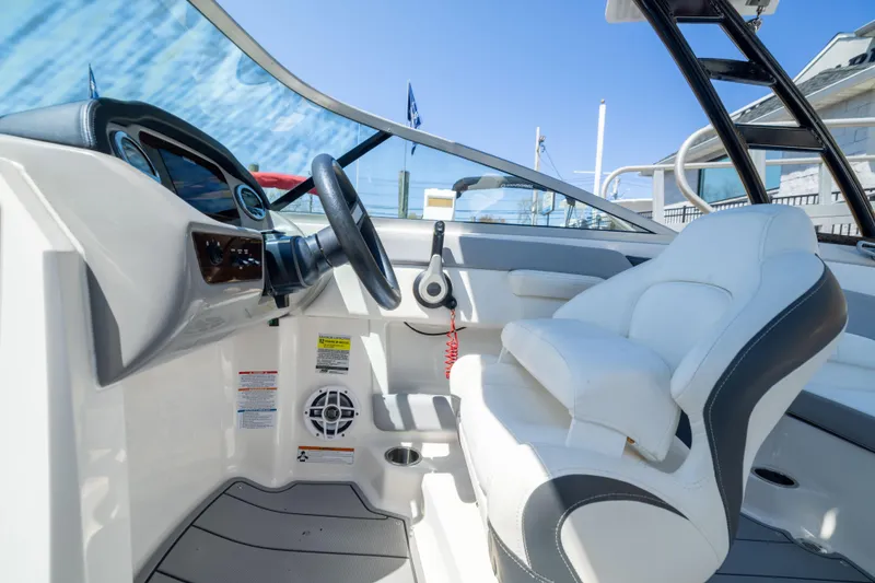 Slide: The Image of 2022 Chaparral 21 SSi OB boat interior with steering wheel and white seating. - 13