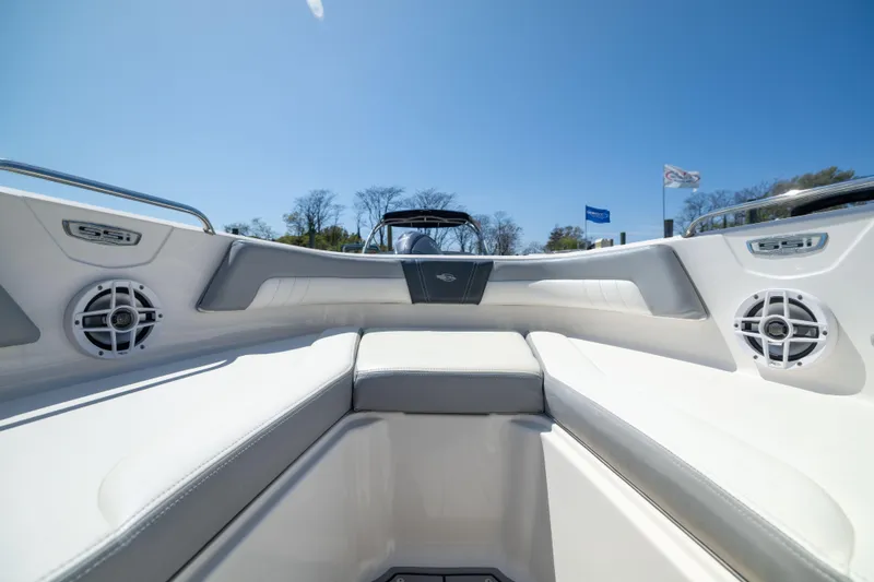 Slide: The Image of 2022 Chaparral 21 SSi OB boat interior with white seating and speakers. - 17