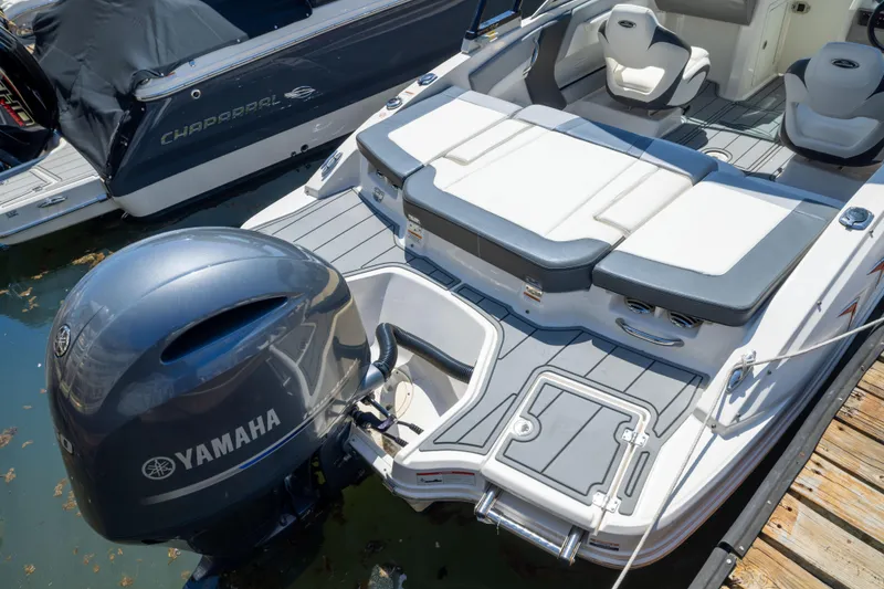 Slide: The Image of 2022 Chaparral 21 SSi OB boat with Yamaha outboard engine, docked on water. - 19