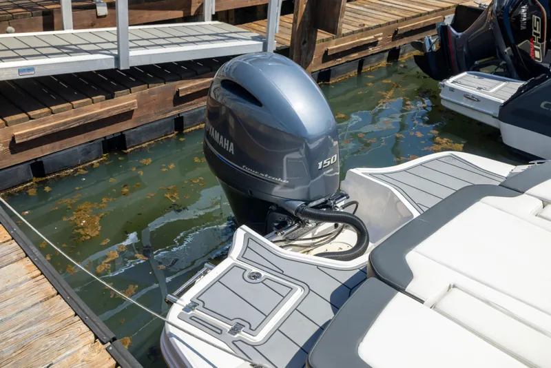 Slide: The Image of 2022 Chaparral 21 SSi OB with Yamaha 150 outboard engine docked at marina. - 20