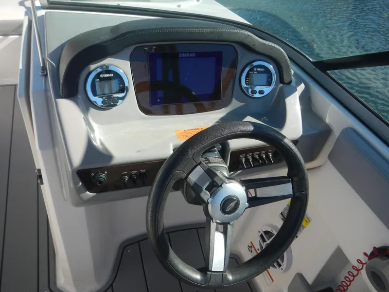 Slide: The Image of 2022 Chaparral 21 SSi OB boat dashboard with steering wheel and digital display. - 3