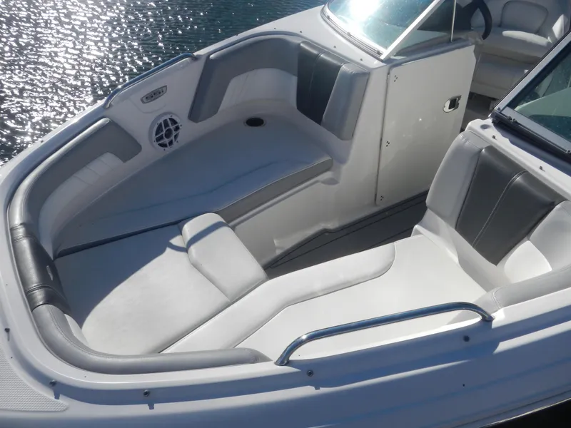 Slide: The Image of 2022 Chaparral 21 SSi OB boat interior with white seating and sleek design. - 7