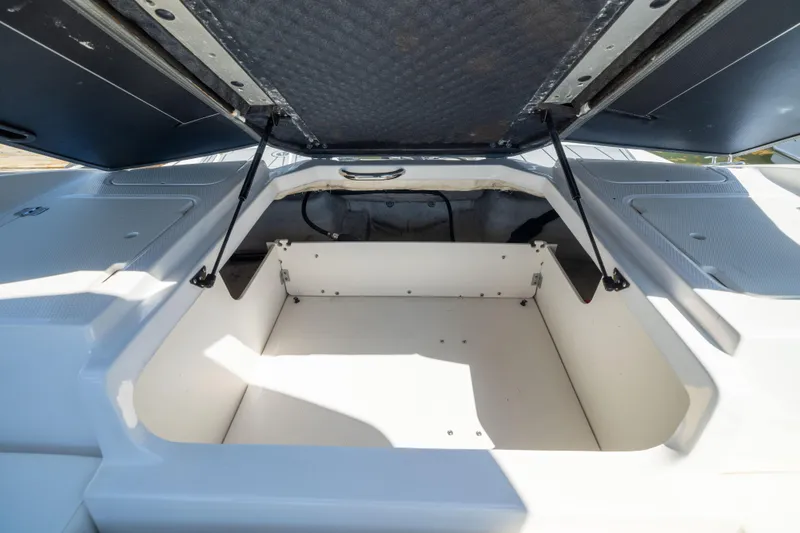 Slide: The Image of Open storage compartment on 2022 Chaparral 21 SSi OB boat, showcasing spacious interior. - 9