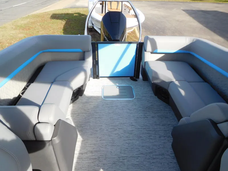 Slide: The Image of 2025 Bennington 24 MFB pontoon boat interior with gray seating and blue accents. - 12
