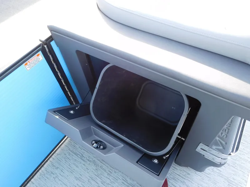 Slide: The Image of 2025 Bennington 24 MFB storage compartment with open hatch on boat deck. - 8