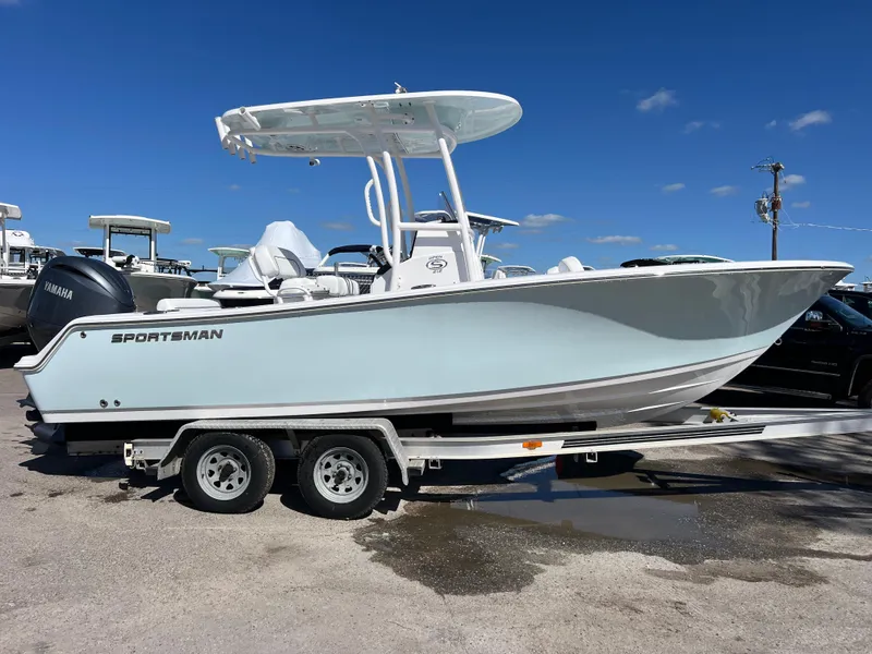 The Image of 2024 Sportsman Open 212 Center Console boat on trailer under clear blue sky. - 0
