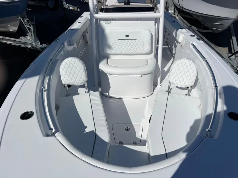 Slide: The Image of 2024 Sportsman Open 212 Center Console boat interior with white seating and storage. - 10