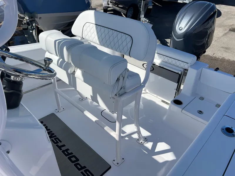 Slide: The Image of 2024 Sportsman Open 212 Center Console boat interior with white seating and steering wheel. - 12