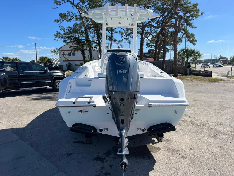 Slide: The Image of 2024 Sportsman Open 212 Center Console boat with Yamaha 150 engine, parked outdoors. - 3