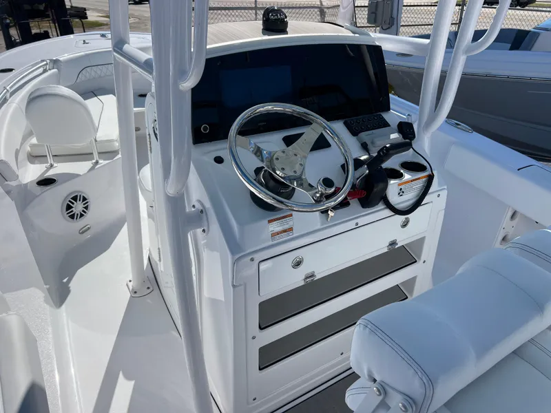 Slide: The Image of 2024 Sportsman Open 212 Center Console boat interior with steering wheel and controls. - 6