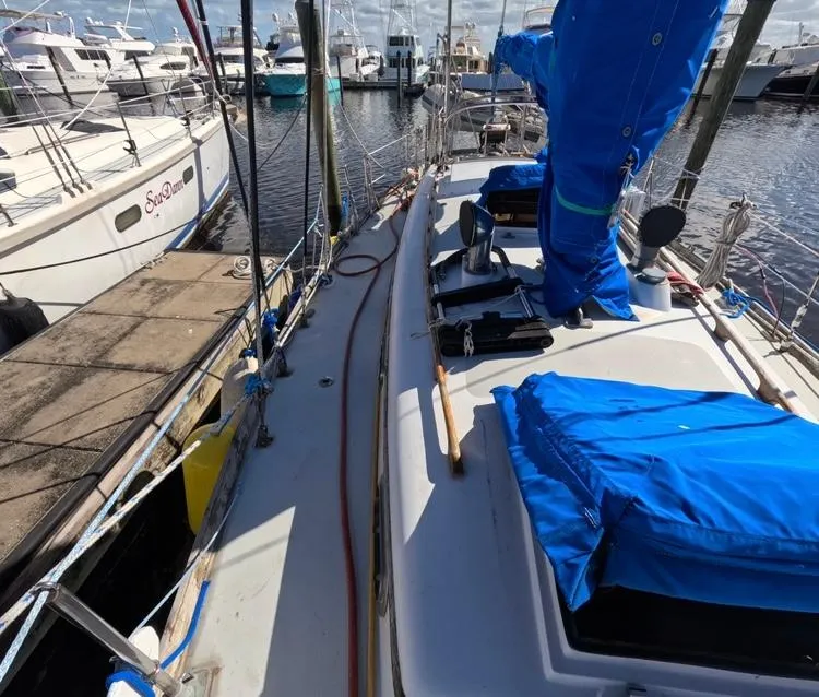 Slide: The Image of 1972 Cheoy Lee Luders 36 sailboat docked at marina, blue covers, clear sky. - 10