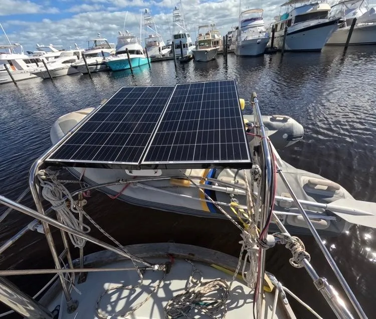 Slide: The Image of 1972 Cheoy Lee Luders 36 sailboat with solar panels docked in a marina. - 11