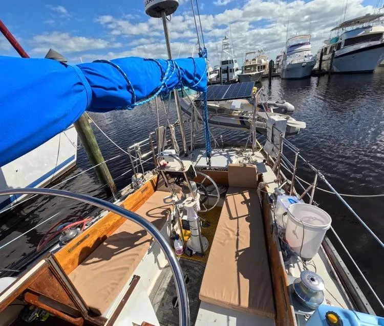 Slide: The Image of 1972 Cheoy Lee Luders 36 sailboat docked, featuring blue sail cover and spacious deck. - 12