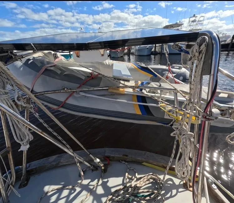 Slide: The Image of 1972 Cheoy Lee Luders 36 sailboat with rigging and dinghy, docked under a sunny sky. - 16
