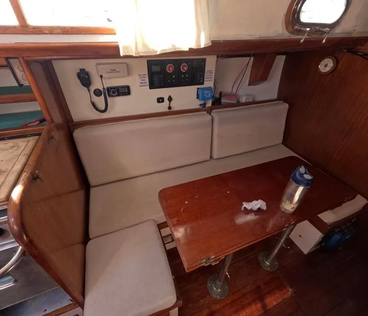 Slide: The Image of 1972 Cheoy Lee Luders 36 yacht interior with wooden table and cushioned seating. - 23