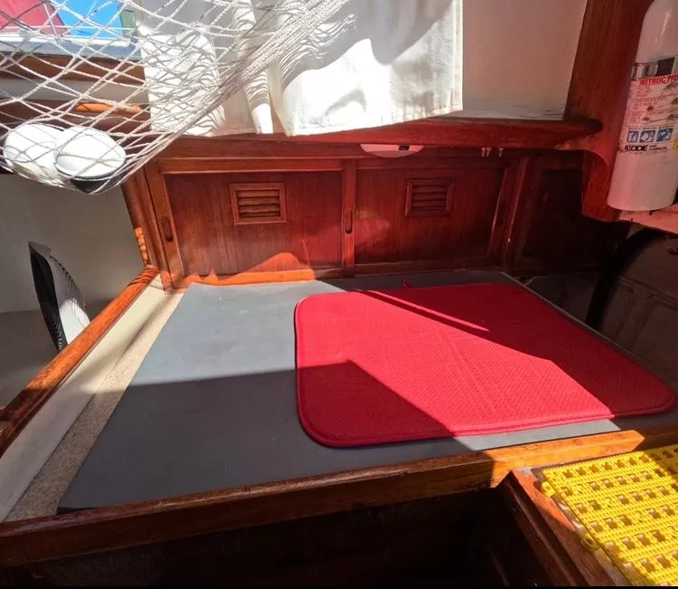 Slide: The Image of Interior of 1972 Cheoy Lee Luders 36 sailboat with red mat and wooden cabinetry. - 27