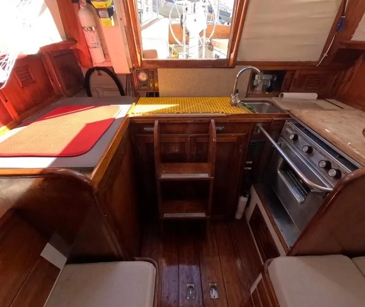 Slide: The Image of Interior of 1972 Cheoy Lee Luders 36 sailboat with wooden cabinetry and compact kitchen. - 38
