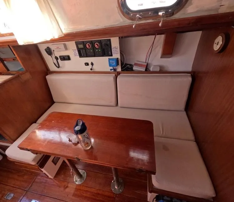 Slide: The Image of Interior of 1972 Cheoy Lee Luders 36 sailboat with wooden table and cushioned seating. - 39