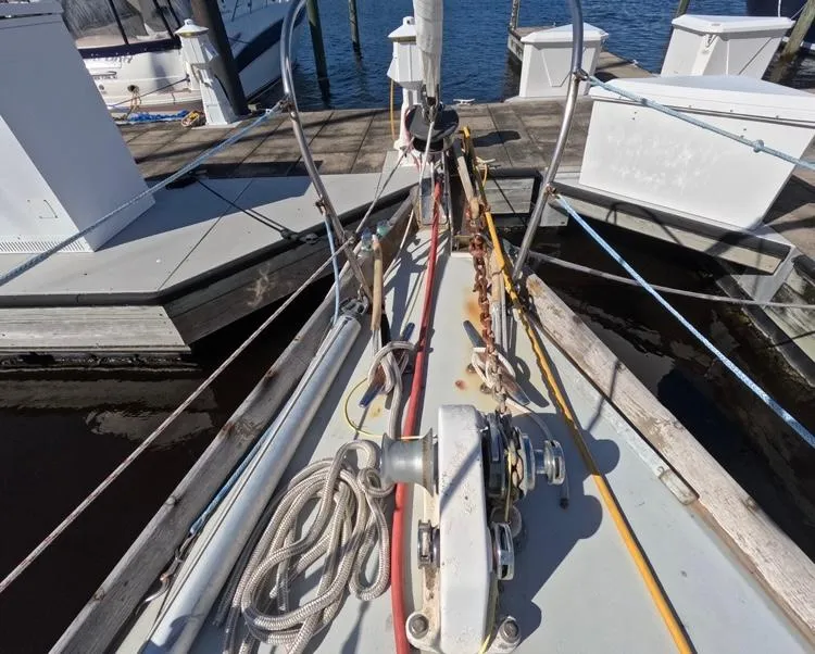 Slide: The Image of 1972 Cheoy Lee Luders 36 sailboat deck with ropes and winch at marina. - 5