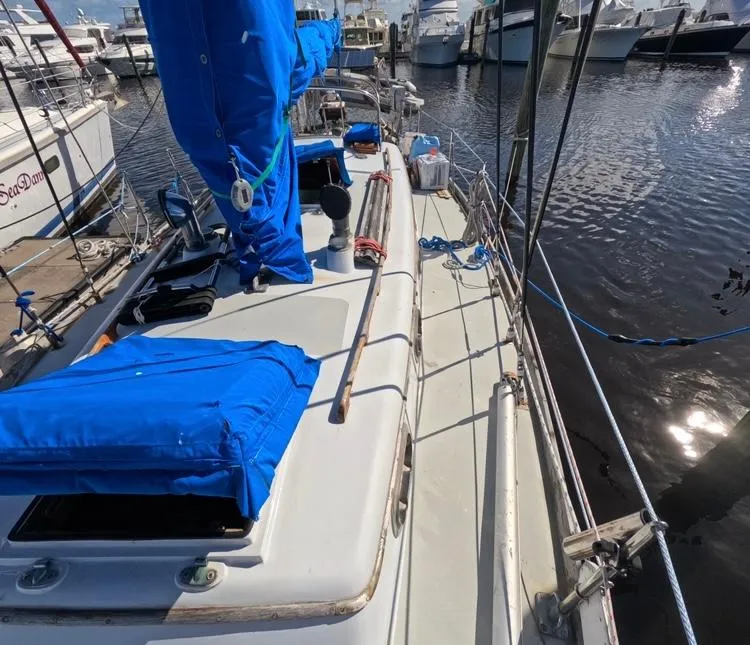 Slide: The Image of 1972 Cheoy Lee Luders 36 sailboat docked at marina, featuring blue sail covers. - 7