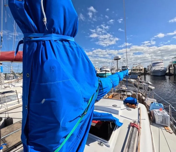 Slide: The Image of 1972 Cheoy Lee Luders 36 sailboat with blue sail cover at marina. - 8