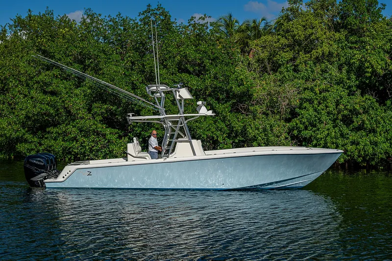 The Image of 2018 SeaVee 370z boat on calm water, surrounded by lush greenery. - 0