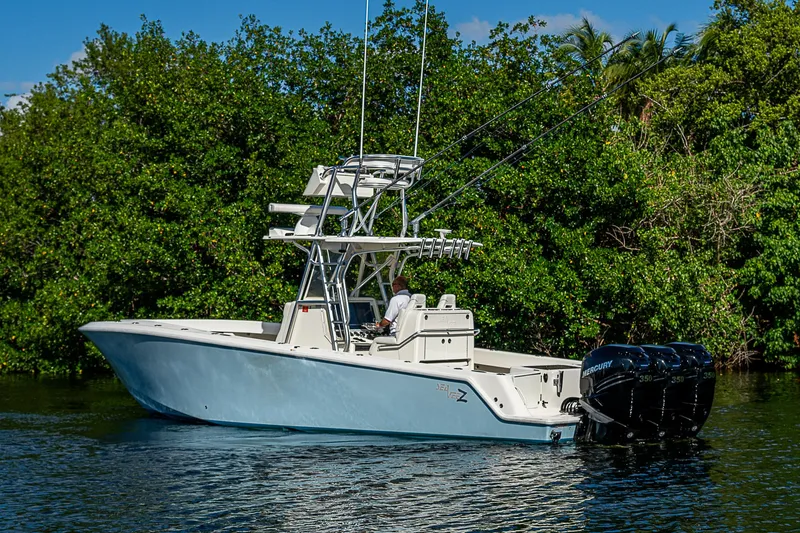 Slide: The Image of 2018 SeaVee 340Z boat with triple engines on a calm waterway. - 1