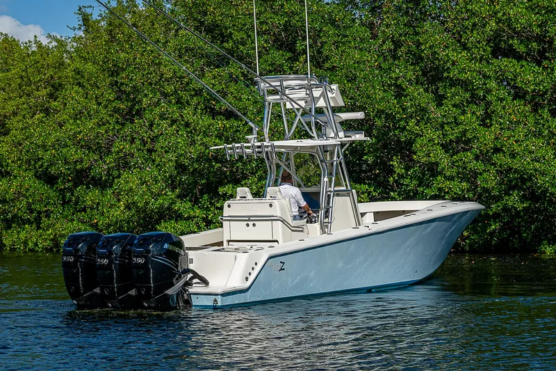 Slide: The Image of 2018 SeaVee 370z boat with triple engines on a calm waterway. - 15