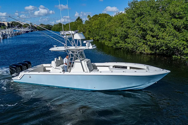 Slide: The Image of 2018 SeaVee 370z boat cruising on a scenic waterway. - 16