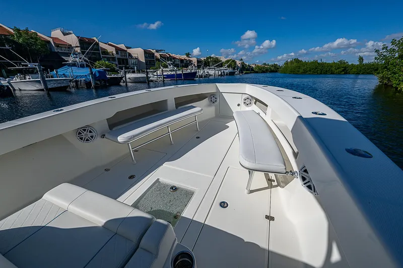 Slide: The Image of 2018 SeaVee 370z boat with spacious deck, docked by waterfront homes. - 22