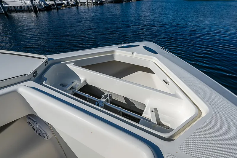 Slide: The Image of 2018 SeaVee 370z boat with open storage compartment on calm water. - 24
