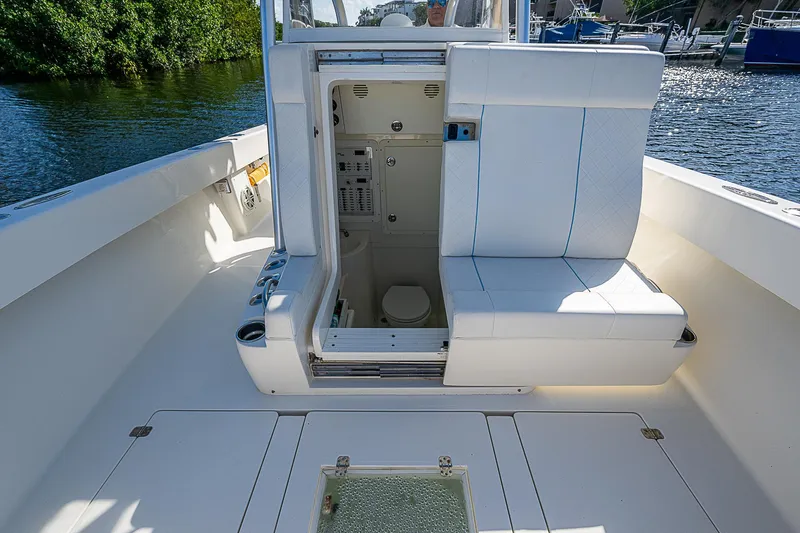 Slide: The Image of 2018 SeaVee 370z boat interior with open cabin door, white seating, and water view. - 26