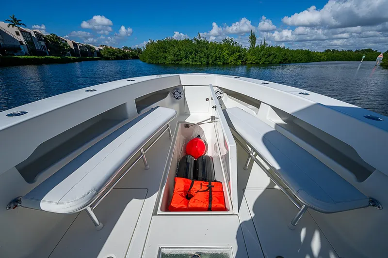 Slide: The Image of 2018 SeaVee 370z boat interior with seating and storage, on a sunny day. - 30