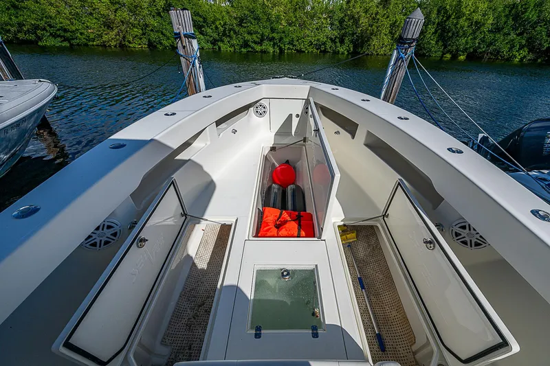 Slide: The Image of 2018 SeaVee 370z boat interior with open storage compartments and safety gear. - 33