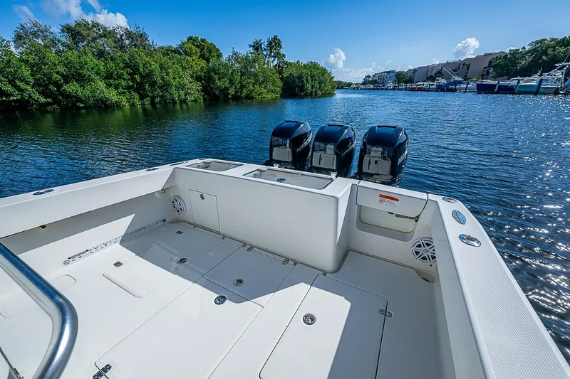 Slide: The Image of 2018 SeaVee 370z boat with triple engines on a serene waterway. - 34