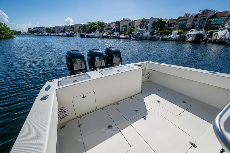 Slide: The Image of 2018 SeaVee 370z boat with triple engines docked in a scenic marina. - 35