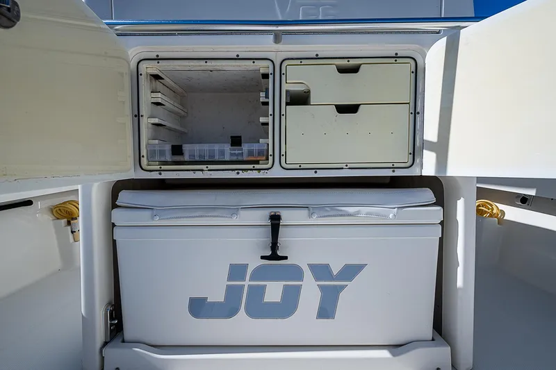 Slide: The Image of 2018 SeaVee 370z boat storage compartments with cooler labeled "JOY." - 41