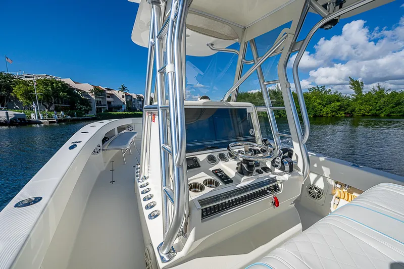 Slide: The Image of 2018 SeaVee 370z boat console with modern controls on a sunny day. - 47