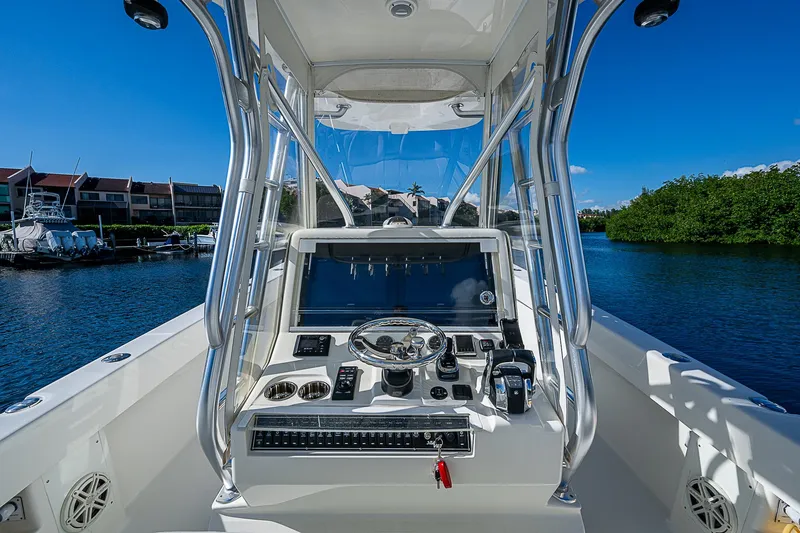 Slide: The Image of 2018 SeaVee 370z boat console with navigation equipment on a sunny day. - 48