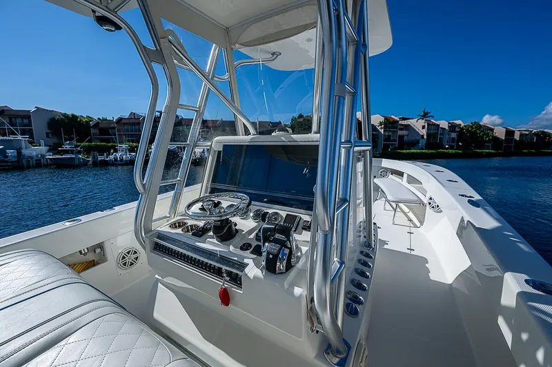 Slide: The Image of 2018 SeaVee 370z boat cockpit with modern controls and waterfront view. - 49