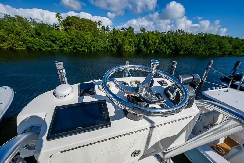 Slide: The Image of 2018 SeaVee 370z boat helm with steering wheel and navigation system. - 51