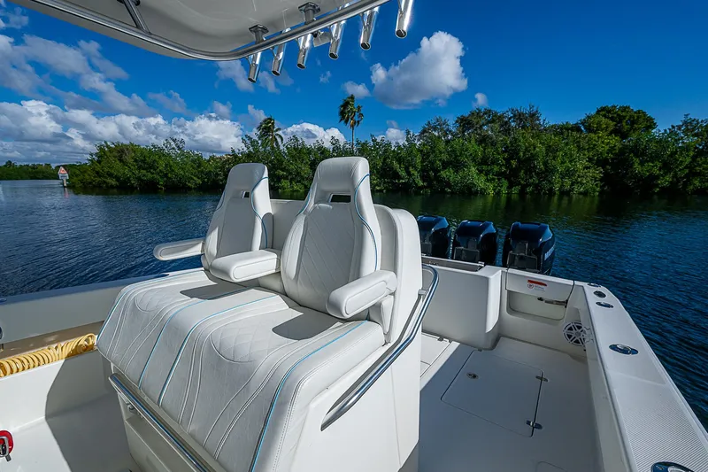 Slide: The Image of 2018 SeaVee 370z boat with dual white seats and triple outboard motors. - 52