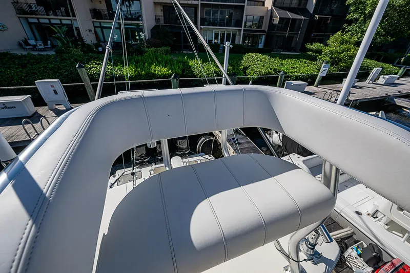 Slide: The Image of 2018 SeaVee 370z boat helm seat with marina background. - 55