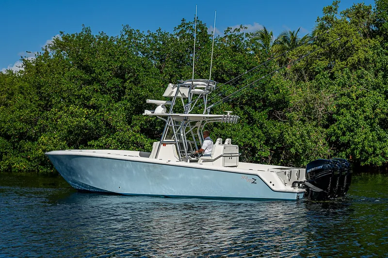 Slide: The Image of 2018 SeaVee 340Z boat on calm water, surrounded by lush greenery. - 6