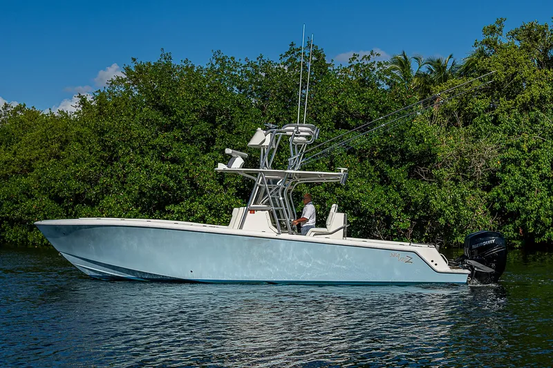 Slide: The Image of 2018 SeaVee 340Z boat on calm water, surrounded by lush greenery. - 7