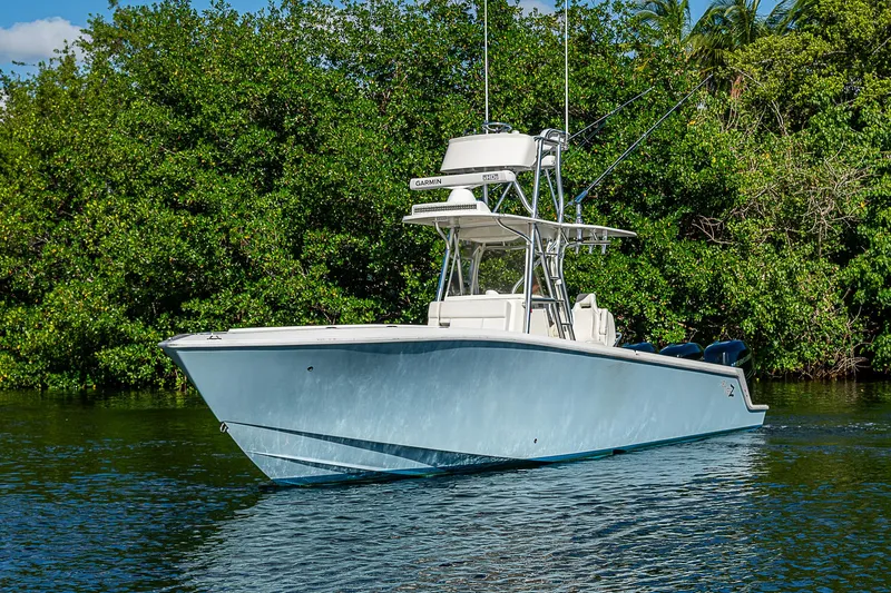 Slide: The Image of 2018 SeaVee 340Z boat on calm water, surrounded by lush greenery. - 9